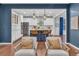 Open-concept kitchen with stainless steel appliances, large island, and stylish pendant lighting at 3438 Cade Ct, Castle Rock, CO 80104