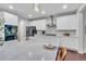 Spacious kitchen with white cabinets, stainless appliances, marble island, and seating at 3438 Cade Ct, Castle Rock, CO 80104