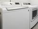 Image featuring a modern white LG brand washer and dryer set with sleek design and electronic controls at 3438 Cade Ct, Castle Rock, CO 80104