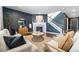 Cozy living room featuring a fireplace, neutral furniture, stylish decor, and dark accent wall at 3438 Cade Ct, Castle Rock, CO 80104