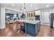 Living area leading into the kitchen with a large island at 3438 Cade Ct, Castle Rock, CO 80104