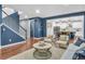 Open-concept living space with blue accent walls, hardwood floors, and seamless flow to the kitchen at 3438 Cade Ct, Castle Rock, CO 80104