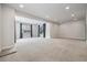Spacious living room with large windows offering plenty of natural light, neutral carpet and fresh neutral paint at 3438 Cade Ct, Castle Rock, CO 80104