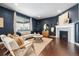 Cozy living room featuring dark walls, neutral furniture, a fireplace, and stylish decor elements at 3438 Cade Ct, Castle Rock, CO 80104