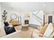 Bright living room with fireplace, modern furniture, dark wood floors, and staircase at 3438 Cade Ct, Castle Rock, CO 80104