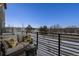 Private balcony with seating and sunflower pillows, overlooking a winter landscape at 2584 Meadows Blvd # E, Castle Rock, CO 80109