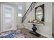 Bright entryway with decorative console table, hardwood floors, and view of staircase at 2584 Meadows Blvd # E, Castle Rock, CO 80109