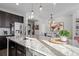 Granite countertop kitchen island with sink and dishwasher at 2584 Meadows Blvd # E, Castle Rock, CO 80109