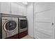 Laundry room with washer, dryer, and additional storage at 2584 Meadows Blvd # E, Castle Rock, CO 80109