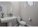 Clean powder room with pedestal sink and toilet at 2584 Meadows Blvd # E, Castle Rock, CO 80109