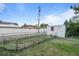Backyard features a chain-link fence, a small shed, and a well-maintained lawn at 205 Beech St, Hudson, CO 80642