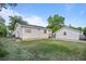 Exterior of home and detached garage showing the back yard with lawn at 205 Beech St, Hudson, CO 80642