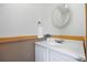 Bathroom featuring a white sink and vanity with natural trim and white walls at 205 Beech St, Hudson, CO 80642