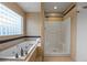 Luxurious bathroom features a soaking tub and a separate shower at 205 Beech St, Hudson, CO 80642
