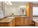 Bright bathroom offers a dual sink vanity with decorative lighting at 205 Beech St, Hudson, CO 80642