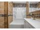 Bathroom featuring a shower-tub combo with a white shower surround and a stylish vanity at 205 Beech St, Hudson, CO 80642