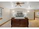 Spacious bedroom featuring a wooden bed frame, ceiling fan, and relaxing decor at 205 Beech St, Hudson, CO 80642