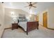 Cozy bedroom featuring a wood-frame bed, a ceiling fan, and a private ensuite bathroom at 205 Beech St, Hudson, CO 80642
