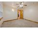Bedroom with carpeted floors, a ceiling fan, natural trim, and an open doorway at 205 Beech St, Hudson, CO 80642
