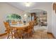Bright dining area featuring a wooden table set with large windows and tile flooring at 205 Beech St, Hudson, CO 80642
