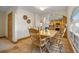 Charming dining area with wooden table set next to open archway and bright windows at 205 Beech St, Hudson, CO 80642
