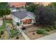 View of home featuring a stone-accented porch, garden beds, and mature landscaping at 205 Beech St, Hudson, CO 80642