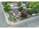Aerial view of well-kept single story home with fenced yard and mature trees at 205 Beech St, Hudson, CO 80642