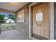 Close-up of a charming front door featuring an oval glass insert and stone accents on the exterior at 205 Beech St, Hudson, CO 80642