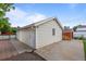Detached garage with a white door, window, and exterior siding; ample space for parking or storage at 205 Beech St, Hudson, CO 80642
