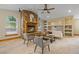 Comfortable living room features a stone fireplace, built-in shelves, and ceiling fan at 205 Beech St, Hudson, CO 80642