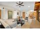 Spacious living room boasts a stone fireplace, access to the kitchen and hardwood trim at 205 Beech St, Hudson, CO 80642