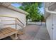 Exterior shot of a backyard patio featuring brick pavers, wooden stairs, and access to the main house at 205 Beech St, Hudson, CO 80642