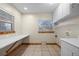 A room featuring a large desk, built in shelving and cabinets at 205 Beech St, Hudson, CO 80642