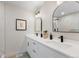 Modern bathroom featuring dual sinks, quartz countertop, and elegant arched mirrors at 6839 E 21St Ave, Denver, CO 80207