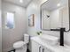 Bathroom features a white vanity, a vessel sink, a modern mirror and a sleek shower at 6839 E 21St Ave, Denver, CO 80207