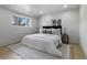 Bedroom with a queen bed, neutral color scheme, and a soft gray rug at 6839 E 21St Ave, Denver, CO 80207