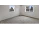 Bedroom showcasing two windows letting in natural light, complimented with gray carpeting at 6839 E 21St Ave, Denver, CO 80207