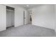 Neutral bedroom with gray carpet, a closet with sliding doors and a door leading into another room at 6839 E 21St Ave, Denver, CO 80207