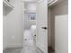 Walk-in closet leads into a bedroom with a large bed and ample natural light at 6839 E 21St Ave, Denver, CO 80207