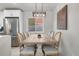 Dining area features a farmhouse table, modern light fixture, and stainless steel refrigerator at 6839 E 21St Ave, Denver, CO 80207