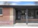 Inviting front entrance with brick accents, large windows, and a stylish black front door at 6839 E 21St Ave, Denver, CO 80207