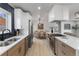 Bright kitchen featuring stainless steel appliances, quartz countertops, and dining area at 6839 E 21St Ave, Denver, CO 80207
