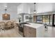 Modern kitchen with an island cooktop, white countertops, and an open layout to the living room at 6839 E 21St Ave, Denver, CO 80207