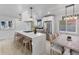 Open kitchen with quartz countertops, stainless steel appliances, island with seating, and modern pendant lighting at 6839 E 21St Ave, Denver, CO 80207