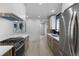 Modern kitchen with stainless steel appliances, quartz countertops and light wood floors at 6839 E 21St Ave, Denver, CO 80207