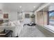 Cozy living room featuring a comfortable sofa, stylish rug, and ample natural light at 6839 E 21St Ave, Denver, CO 80207