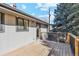 Exterior view of a back deck with wood planks and a dark metal fence at 10121 W 70Th Dr, Arvada, CO 80004