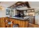 Home wet bar in basement with dark counter and barstool seating at 10121 W 70Th Dr, Arvada, CO 80004