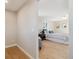 Bedroom view from the hallway, features a door to the exterior, a large window, light colored walls and hardwood floors at 10121 W 70Th Dr, Arvada, CO 80004