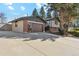 A two-story home features a two-car garage with brick accents and a paved driveway at 10121 W 70Th Dr, Arvada, CO 80004